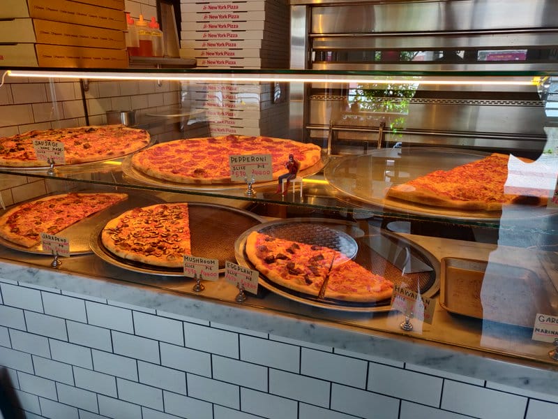 Freshly cooked New York style pizzas ready to go